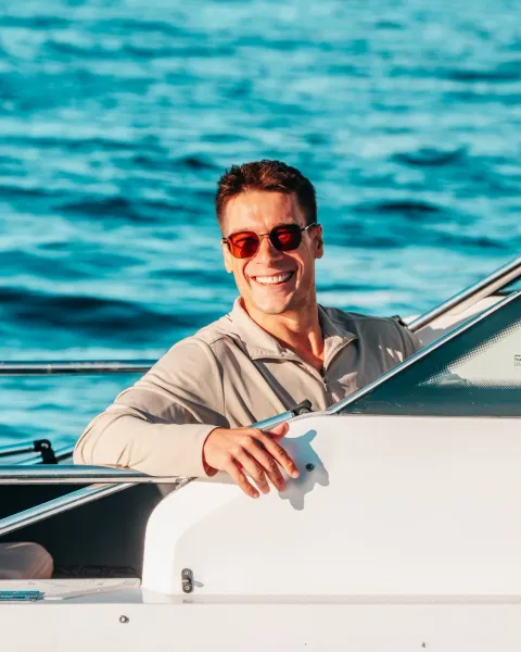 Captain Jeremy Wolff at the helm of Sea La Vie on Moreton Bay